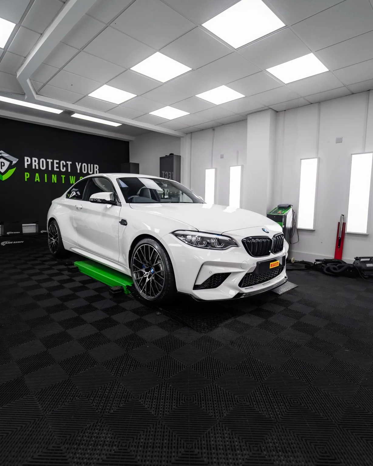 A white BMW M2 in the studio